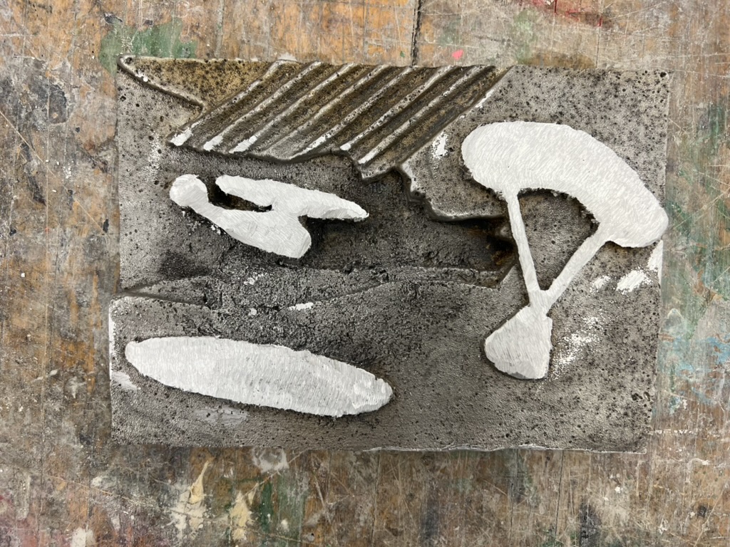 Finished aluminum casting with polished skydiver and parachute relief