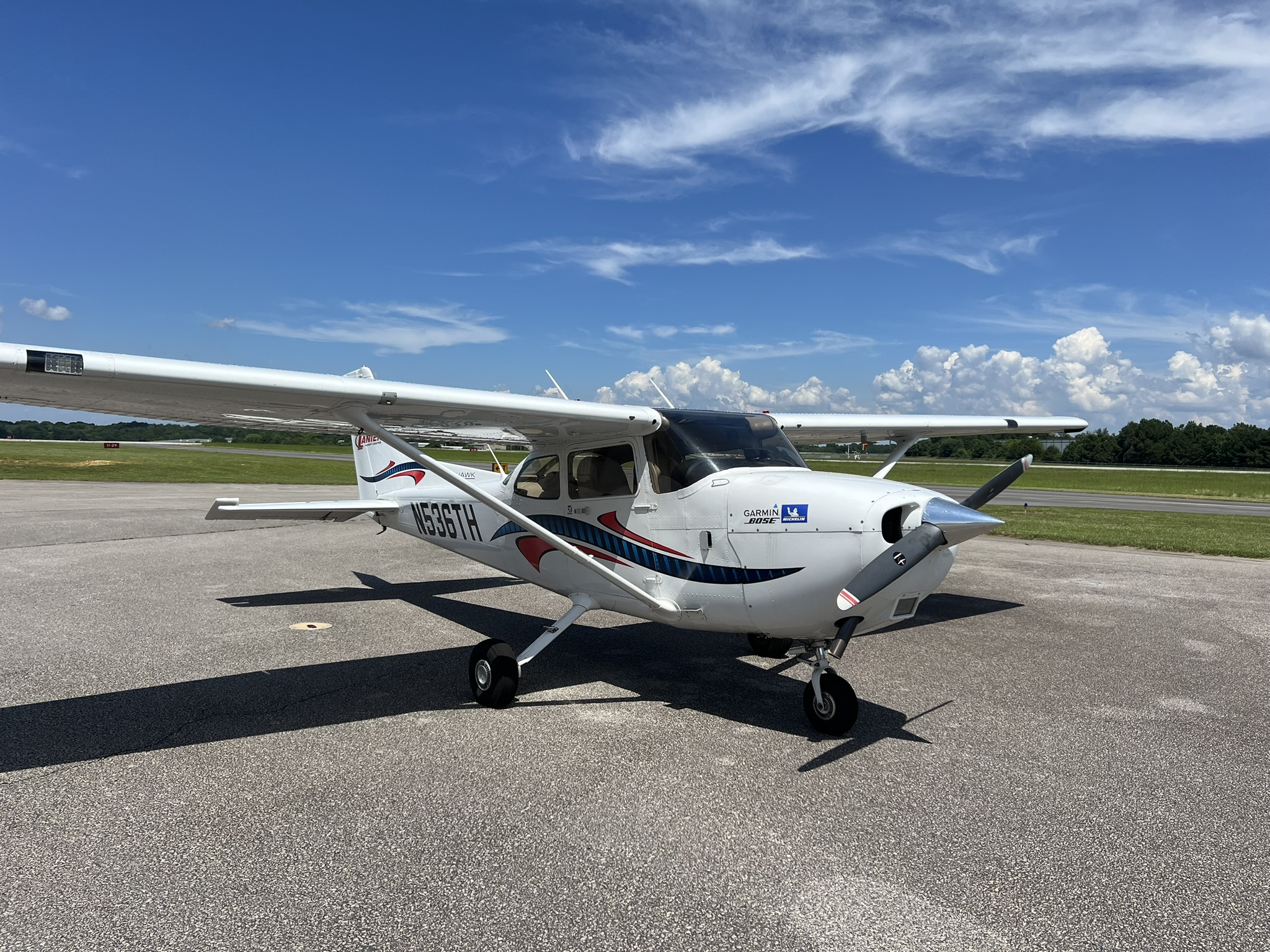 Cessna 172 on the tarmac in white with blue and red accents