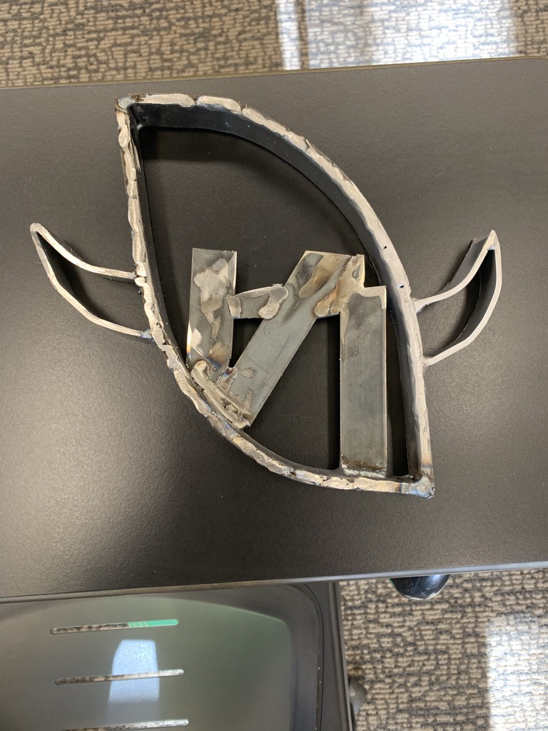 Welded ND monogram inside a football-shaped steel frame