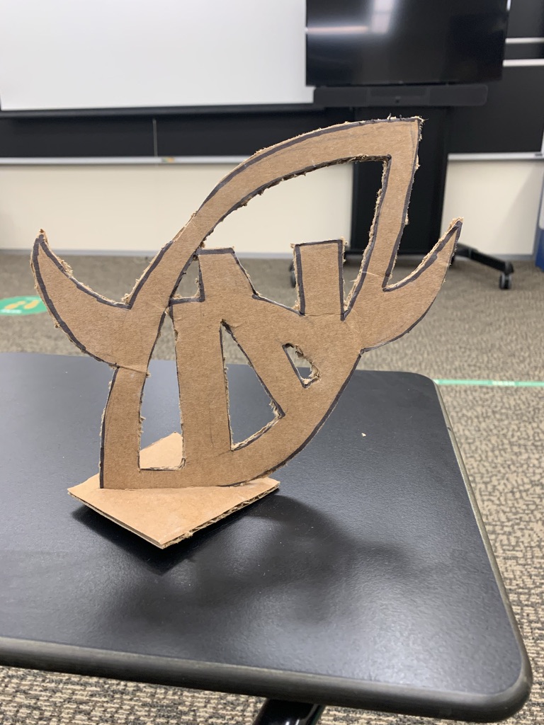 In-progress steel N emblem trophy with weld and grind marks on a workbench